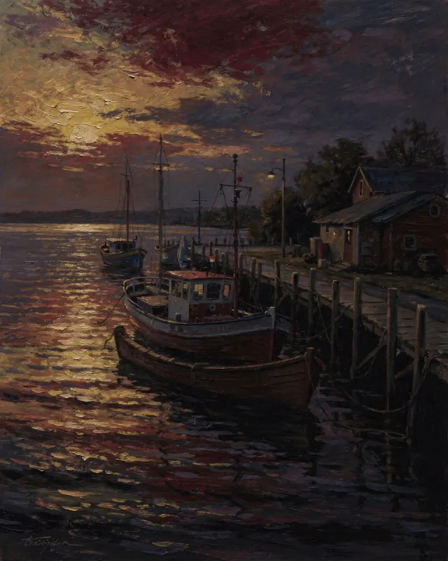 fishing boats under a burning sunset