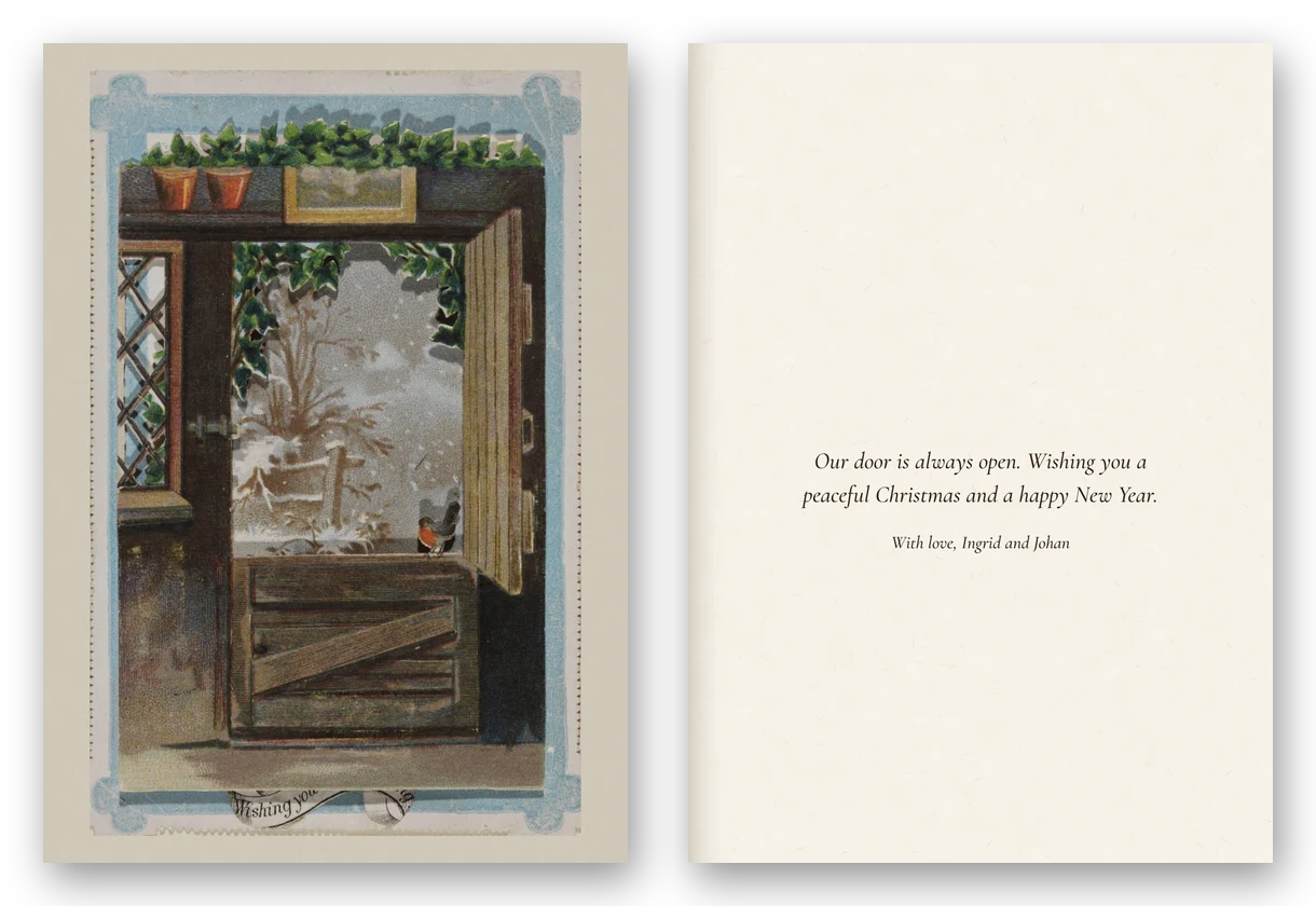 A cottage window opens onto a snowy garden under holly, with a robin on the sill, framed in pale blue, beside the open card and a message.