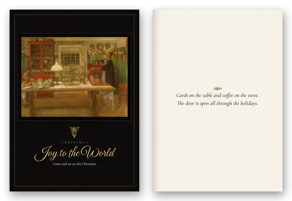 A tall dark card with Carl Larsson's painting of a table set by lamplight for an evening game, lettered Joy to the World in gold, beside the open card.