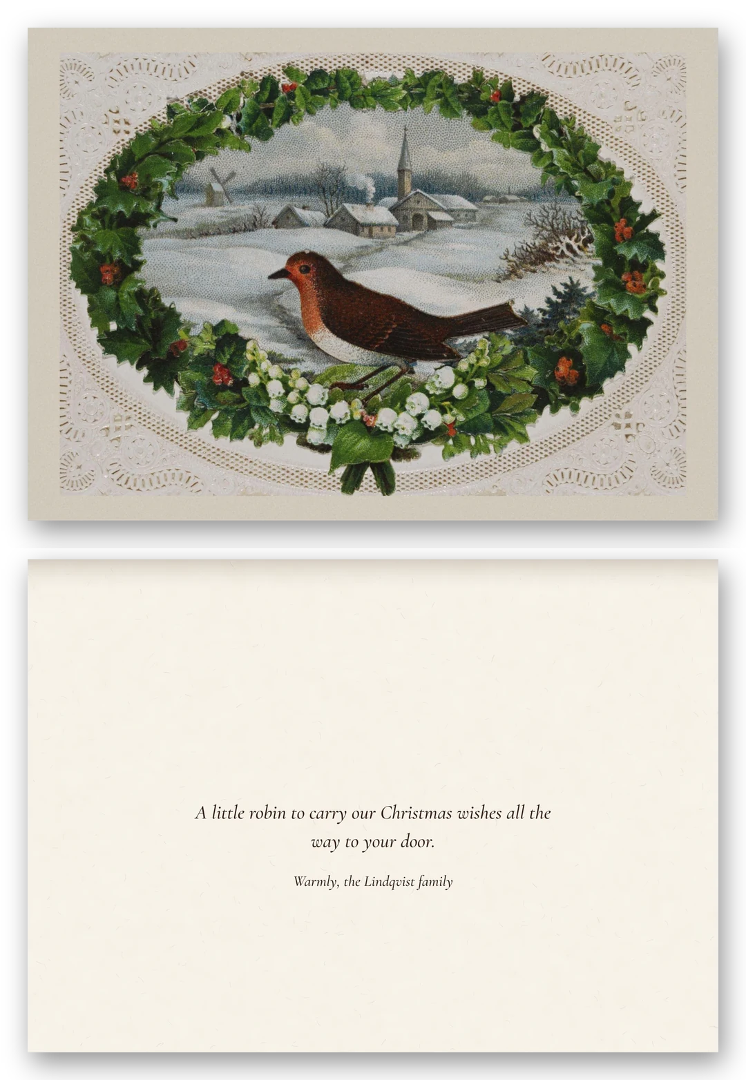 A robin sits in a wreath of holly and mistletoe around a snowy village with a church and windmill, inside a white lace-paper border, above the open card and a short message.
